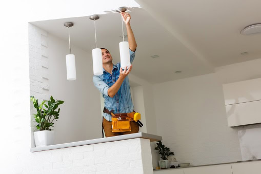 This is a picture of an electrician preforming Lighting Installations